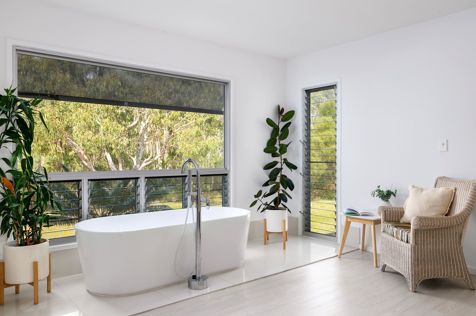 Freestanding bathtub offers a serene retreat with a breathtaking view of the property’s grounds and the surrounding Australian bushland